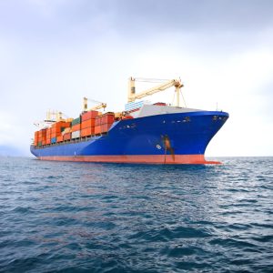commercial container ship with dramatic sky